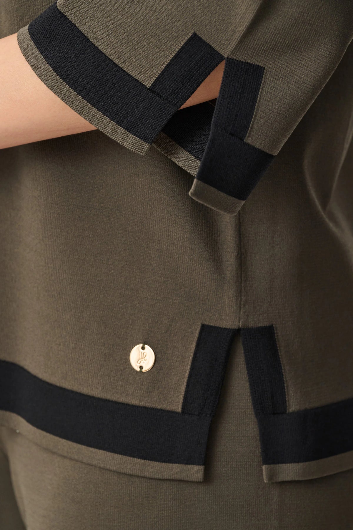 Close-up of sleeve, fabric or embellishment detail on Joseph Ribkoff Sweater Knit Colour Block Top in Avocado/Black, style 253909F26