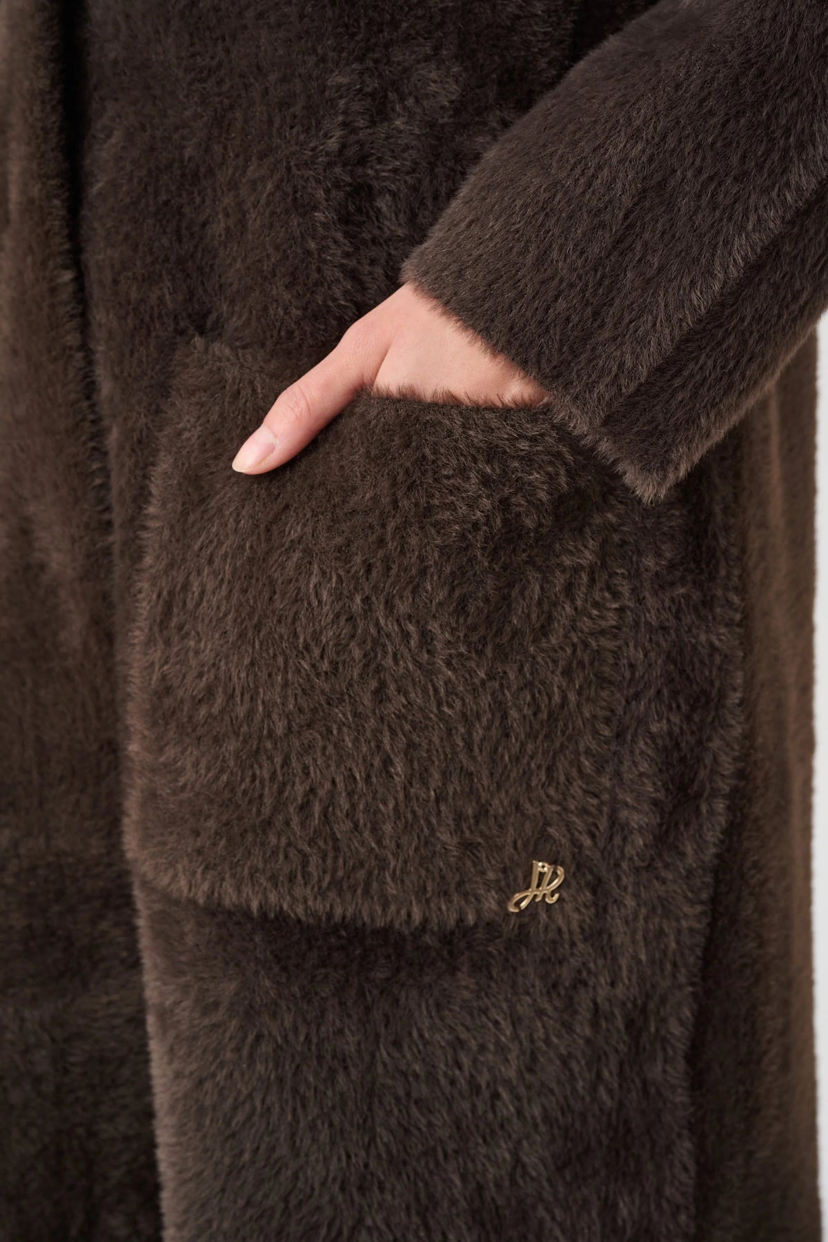 Close-up of neckline and upper-body and pocket edetails on Joseph Ribkoff Detachable Faux-Fur Shawl Collar Coat in mocha, style 263973ket 