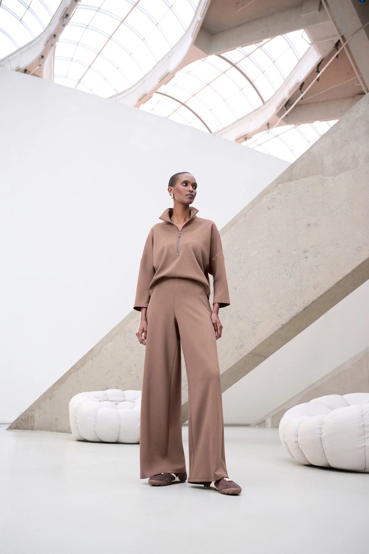  Joseph Ribkoff 263613 in mink jumpsuit outfit in a modern architectural setting