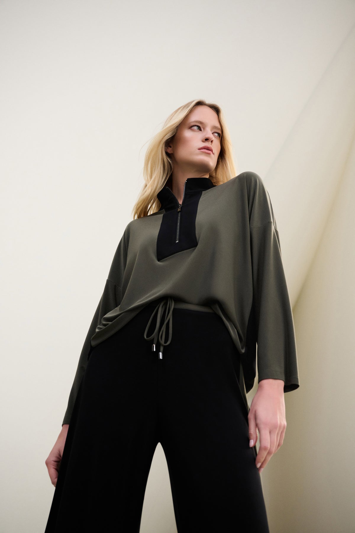 Joseph Ribkoff Color Block Zip-Collar Top in Avocado/Black, style 263606 shown at a three-quarter angle