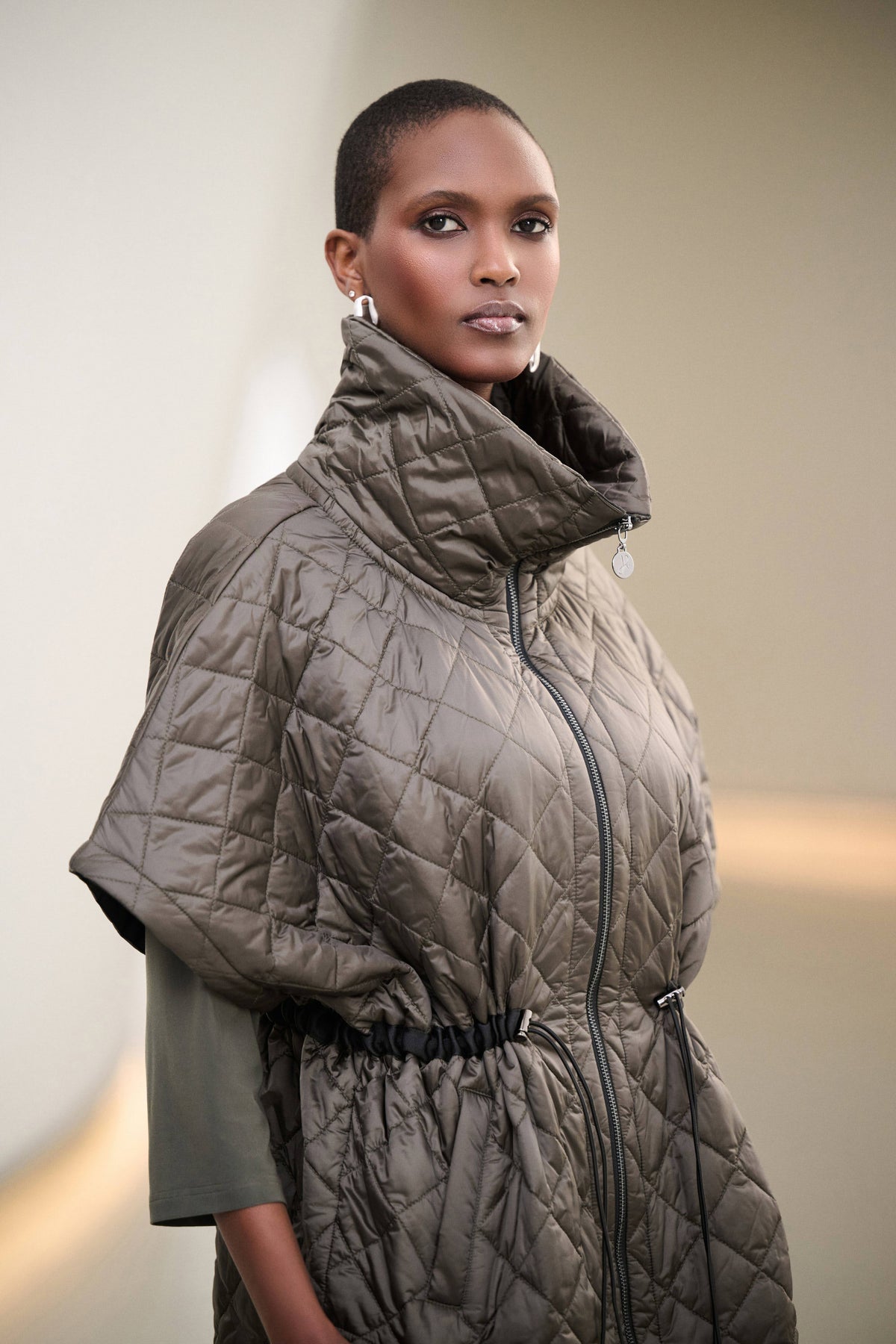 Joseph Ribkoff Quilted Funnel-Neck Vest in Avocado, style 263643 shown at a three-quarter angle