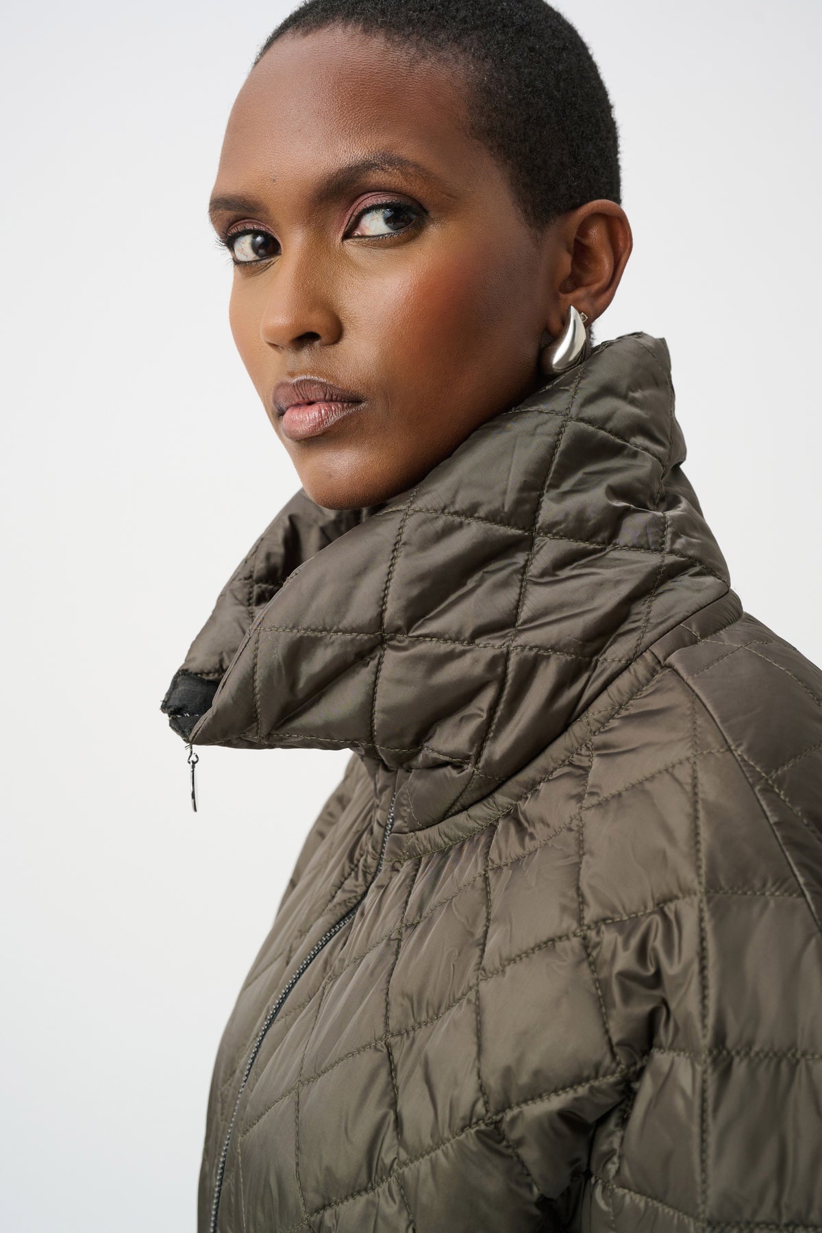 Close-up of neckline and upper-body details on Joseph Ribkoff Quilted Funnel-Neck Vest in Avocado, style 263643