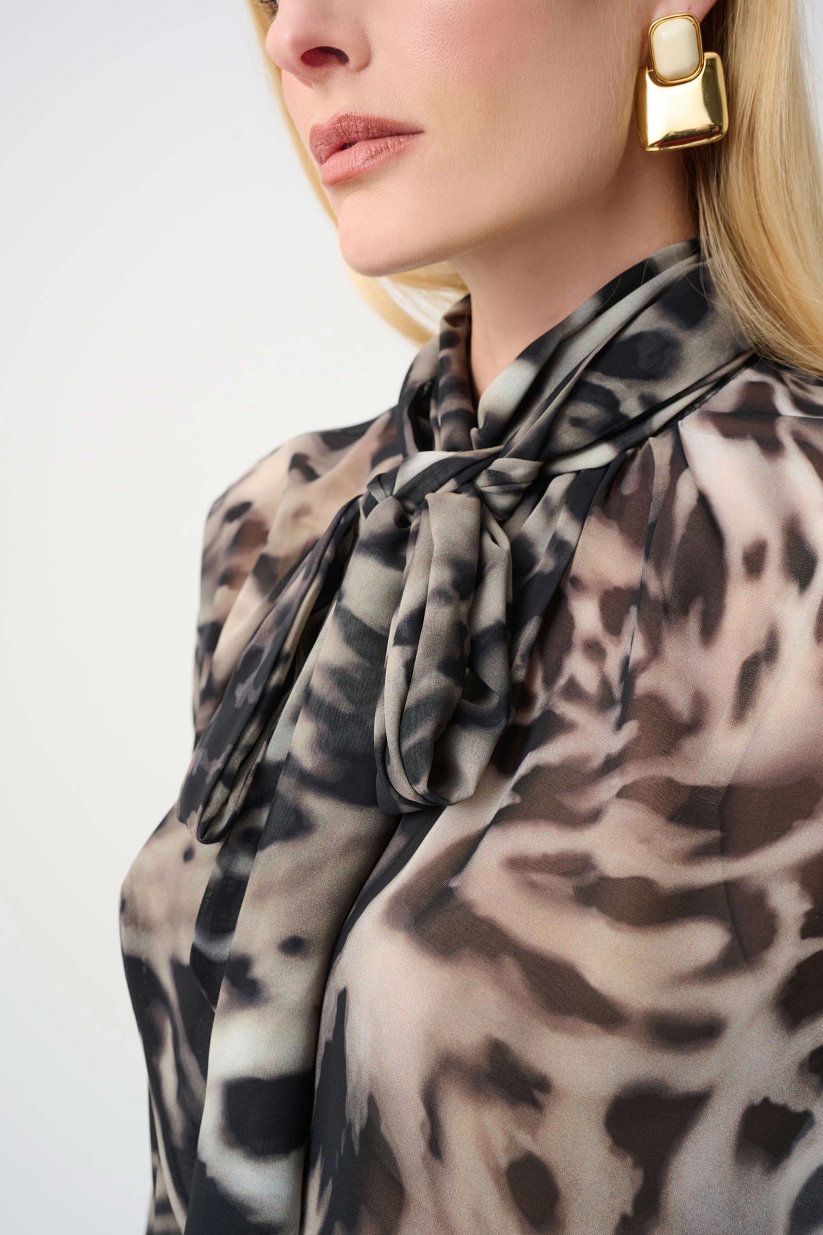 Close-up of neckline and upper-body details on Joseph Ribkoff Animal-Print Sheer Tie-Neck Blouse in Grey/Multi, style 263743