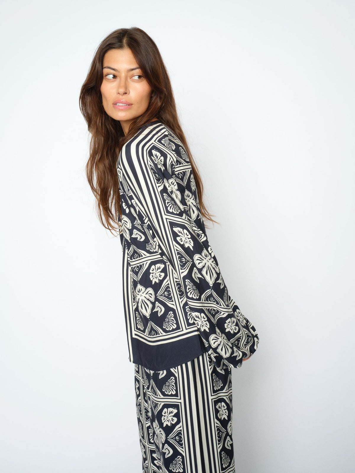 Model wearing MMikey linocut blouse in navy side view
